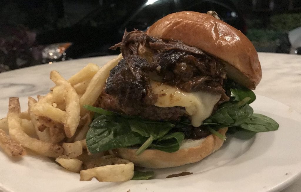 Frugal Foodie Waterside Market Vineyard Haven signature burger is topped with melted brie, balsamic onion jam, baby spinach & shredded short rib and gravy