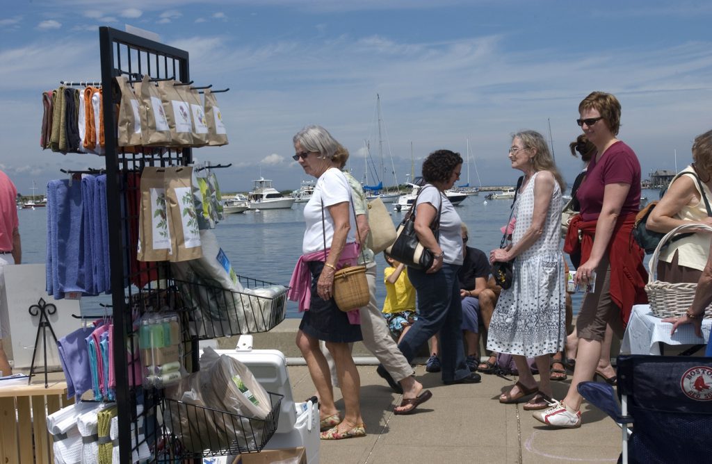 Save the Date for These Martha's Vineyard Summer Events in 2024 HarborFest Visitors walking along the Oak Bluffs harbor.
